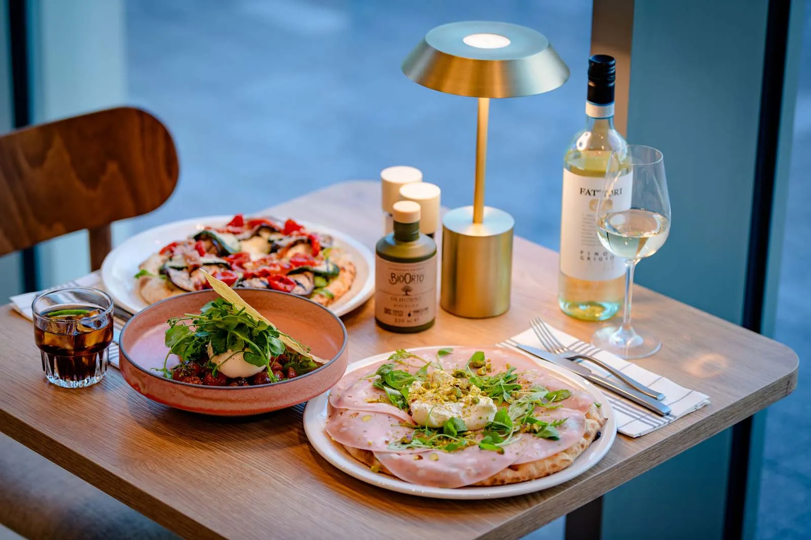 A coke, salad and wine with pizza