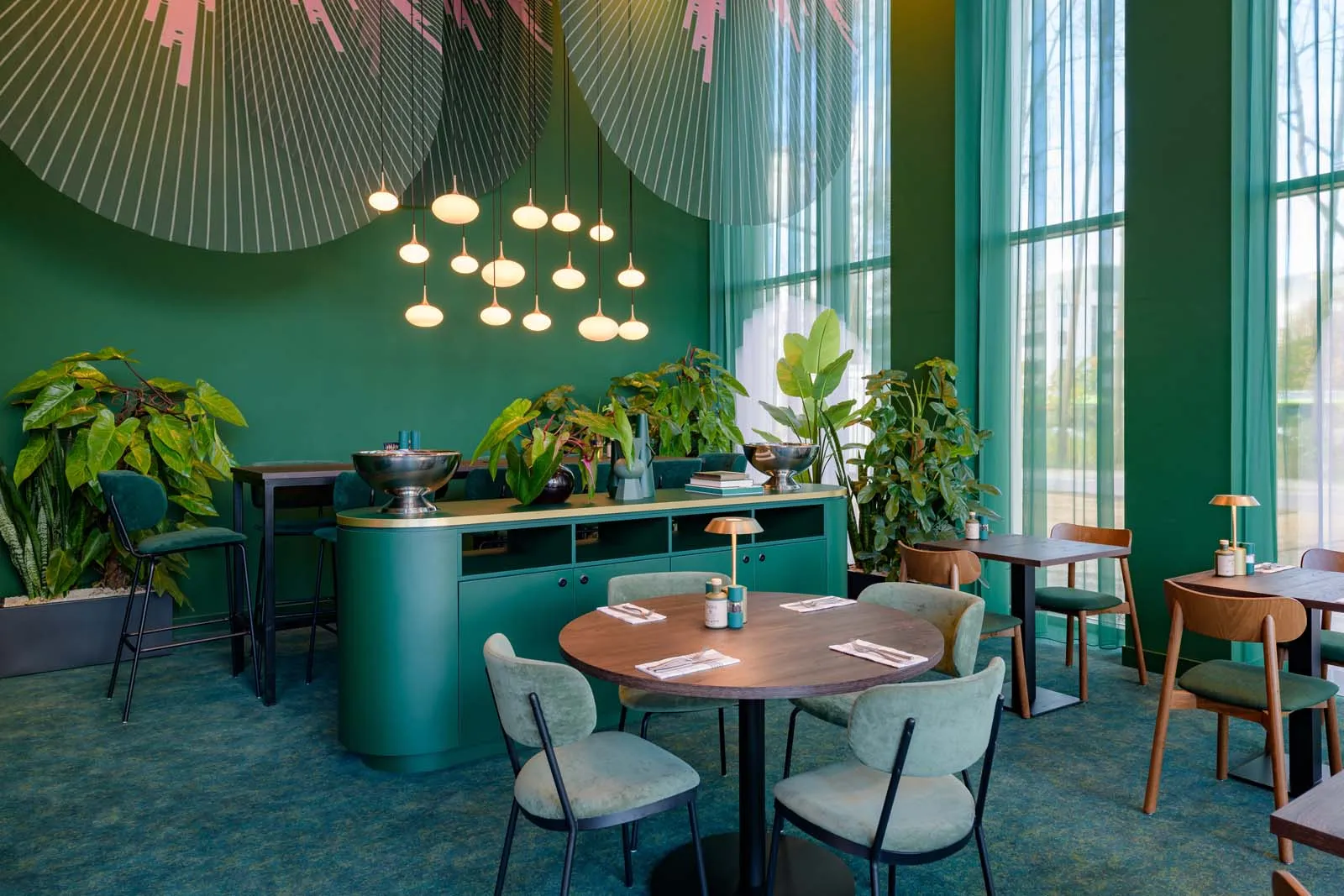 Many tables, seating areas, and plants